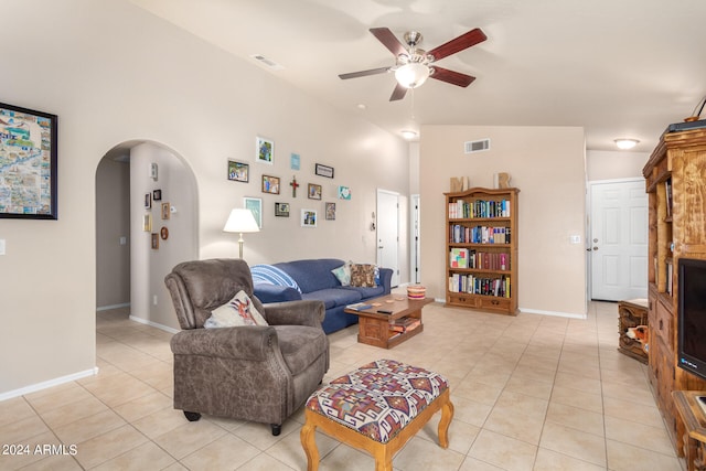 living room with light tile patterned floors, vaulted ceiling, and ceiling fan