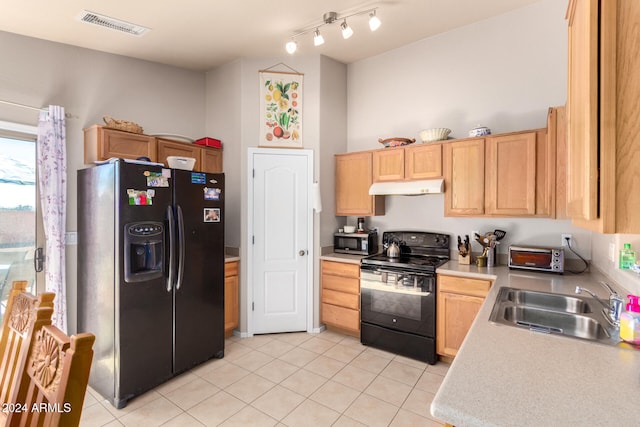 kitchen featuring black appliances, sink, light brown cabinetry, and light tile patterned floors