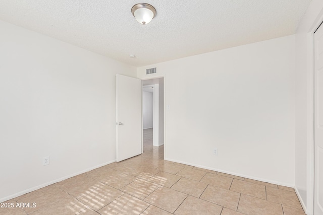 spare room featuring a textured ceiling