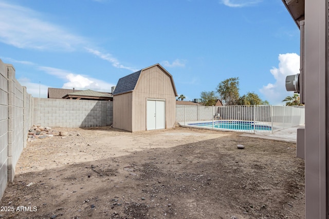 view of yard with a fenced in pool and a storage unit