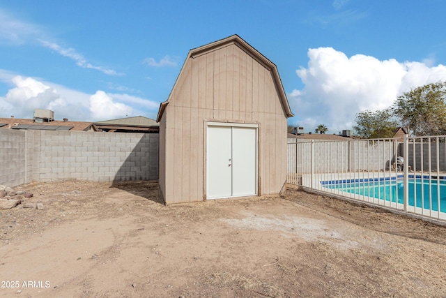 view of outdoor structure featuring a fenced in pool