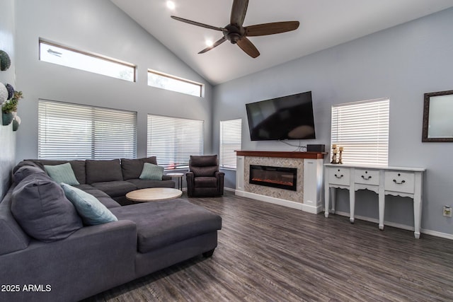 13709 W Rovey Ave, Litchfield Park, AZ 85340 - living room featuring ceiling fan, wood finished floors, a glass covered fireplace, baseboards, and high vaulted ceiling
