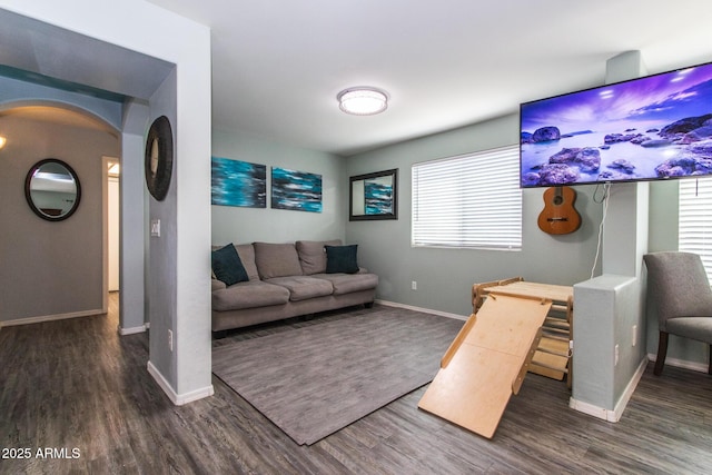 13709 W Rovey Ave, Litchfield Park, AZ 85340 - living room with baseboards, wood finished floors, and arched walkways
