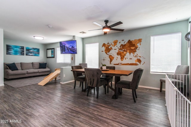 13709 W Rovey Ave, Litchfield Park, AZ 85340 - dining area with baseboards, a ceiling fan, and dark wood-style floors