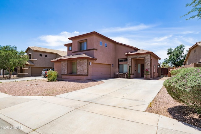13709 W Rovey Ave, Litchfield Park, AZ 85340 - view of front facade featuring driveway, stucco siding, a tile roof, a garage, and stone siding