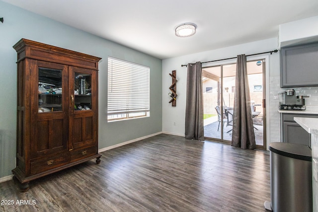 13709 W Rovey Ave, Litchfield Park, AZ 85340 - unfurnished dining area with dark wood finished floors and baseboards
