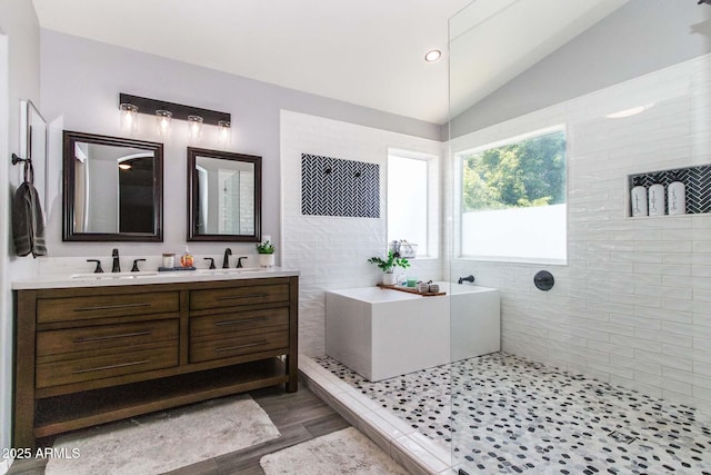 13709 W Rovey Ave, Litchfield Park, AZ 85340 - full bathroom featuring lofted ceiling, double vanity, a walk in shower, wood finished floors, and a bathtub