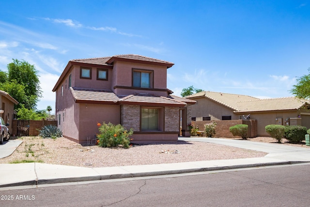 13709 W Rovey Ave, Litchfield Park, AZ 85340 - view of front of property with stucco siding, a tiled roof, stone siding, and a gate
