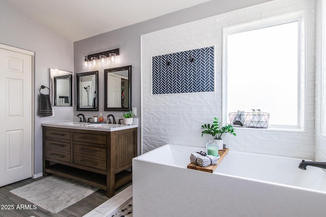 13709 W Rovey Ave, Litchfield Park, AZ 85340 - full bathroom featuring a freestanding bath, double vanity, and wood finished floors
