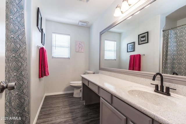 13709 W Rovey Ave, Litchfield Park, AZ 85340 - bathroom featuring healthy amount of natural light, toilet, vanity, and wood finished floors