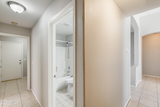 1037 E Baylor Ln, Gilbert, AZ 85296 - hallway featuring light tile patterned floors and arched walkways