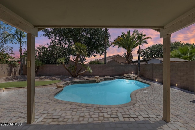 1037 E Baylor Ln, Gilbert, AZ 85296 - pool at dusk featuring a patio area and a fenced backyard