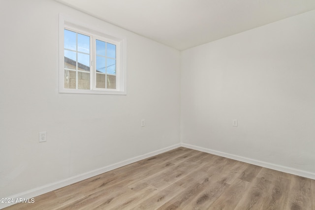 empty room with light hardwood / wood-style flooring