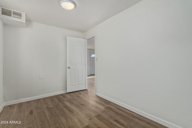 spare room with dark hardwood / wood-style flooring