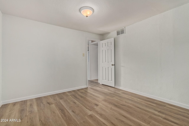 empty room with hardwood / wood-style floors