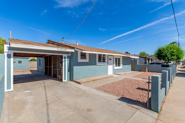 single story home featuring a carport