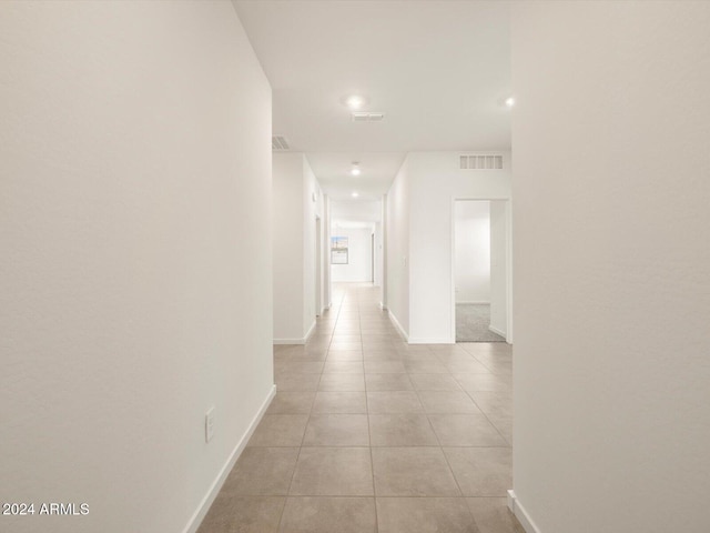 corridor featuring light tile patterned floors