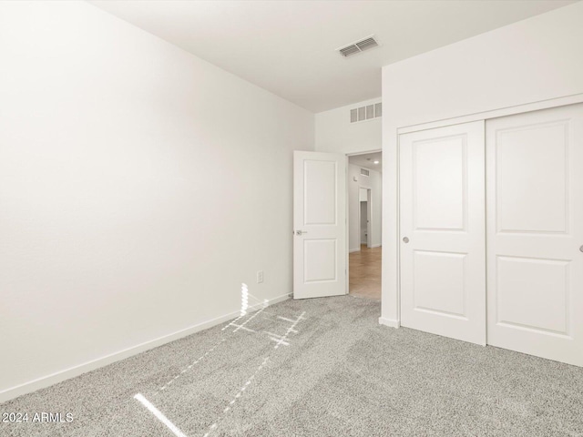 unfurnished bedroom with a closet and carpet