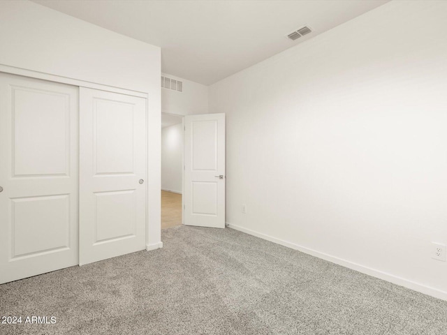 unfurnished bedroom featuring a closet and carpet floors