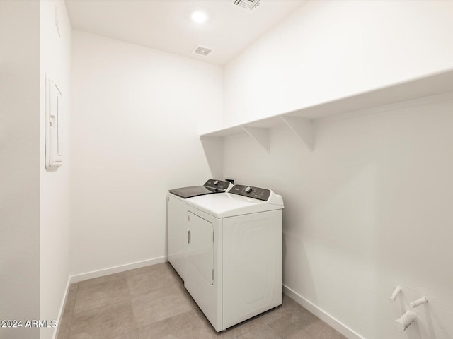 washroom featuring electric panel and washing machine and dryer