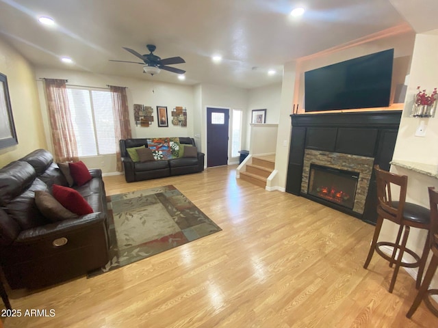 4805 E Kachina Trl Unit 25, Phoenix, AZ 85044 - living area with light wood-type flooring, ceiling fan, a stone fireplace, recessed lighting, and baseboards