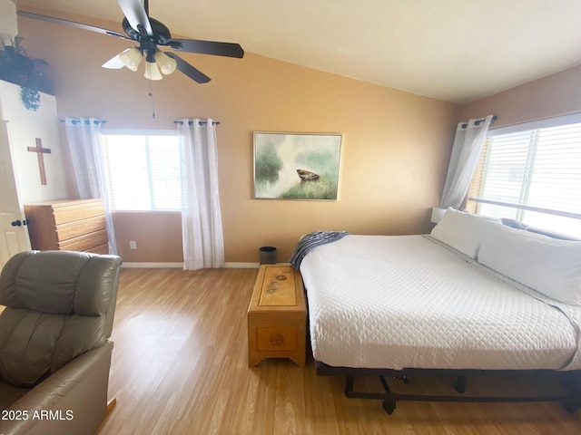 4805 E Kachina Trl Unit 25, Phoenix, AZ 85044 - bedroom featuring multiple windows, vaulted ceiling, light wood-type flooring, baseboards, and a ceiling fan