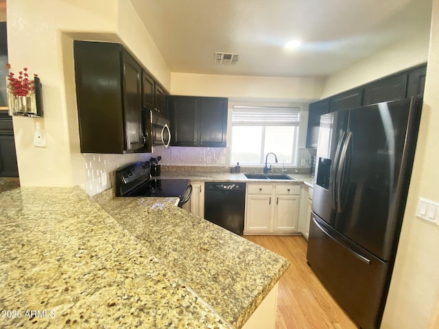 4805 E Kachina Trl Unit 25, Phoenix, AZ 85044 - kitchen featuring black appliances, a sink, light wood-type flooring, and light stone countertops