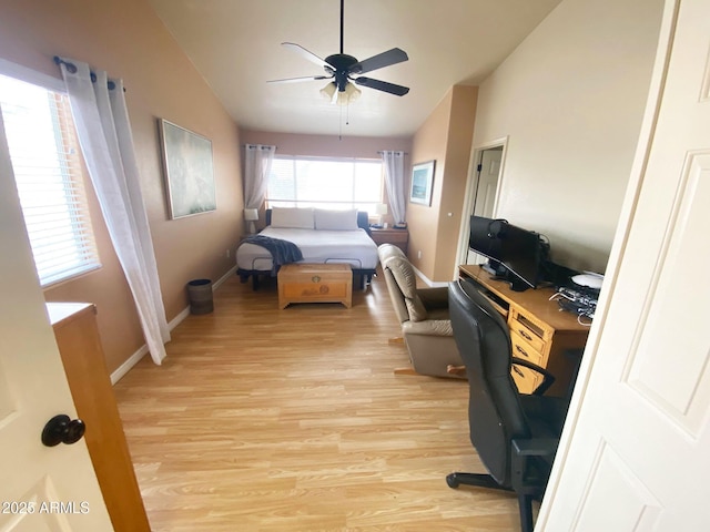 4805 E Kachina Trl Unit 25, Phoenix, AZ 85044 - bedroom featuring light wood-style floors, vaulted ceiling, an office area, baseboards, and a ceiling fan
