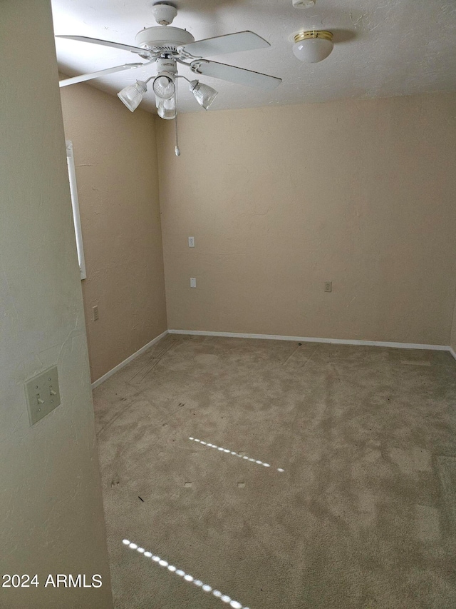 empty room with ceiling fan and carpet flooring