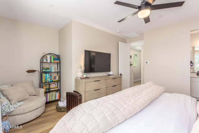 bedroom with visible vents, a ceiling fan, and light wood-style floors