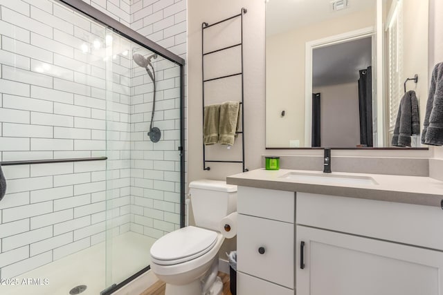 full bath with visible vents, vanity, a shower stall, and toilet