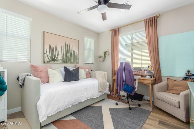 bedroom with a ceiling fan and wood finished floors