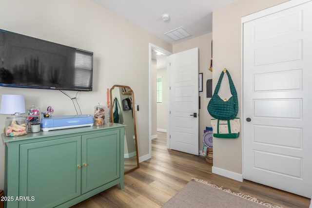 entrance foyer featuring light wood finished floors and baseboards