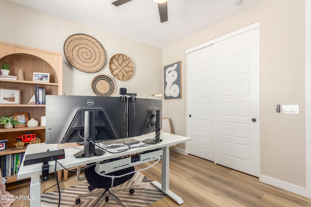 office area with ceiling fan, baseboards, and wood finished floors