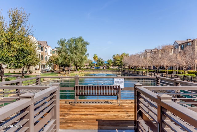 dock area featuring a water view and a residential view