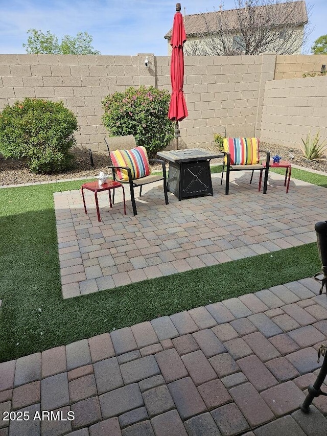 view of patio / terrace featuring an outdoor fire pit