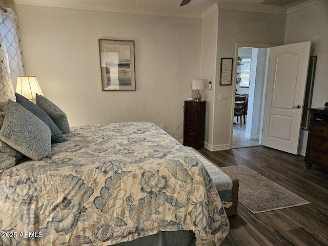 bedroom with ornamental molding and dark wood-type flooring