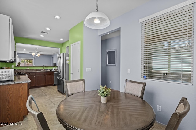 dining room featuring a chandelier, visible vents, light tile patterned floors, and recessed lighting