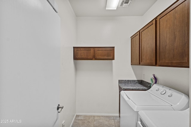 clothes washing area featuring cabinet space, baseboards, light tile patterned floors, visible vents, and washing machine and dryer