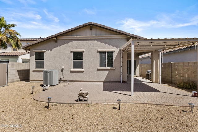rear view of house with a patio, a fenced backyard, stucco siding, a tiled roof, and central air condition unit