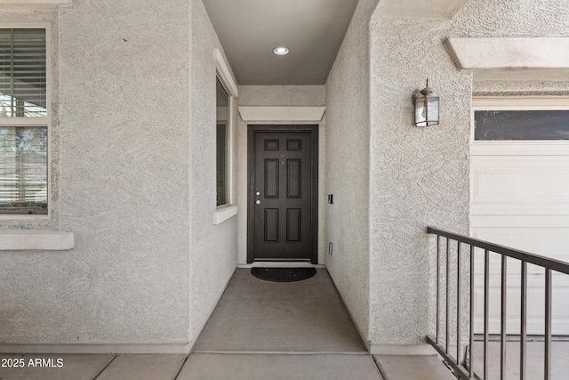 property entrance with stucco siding