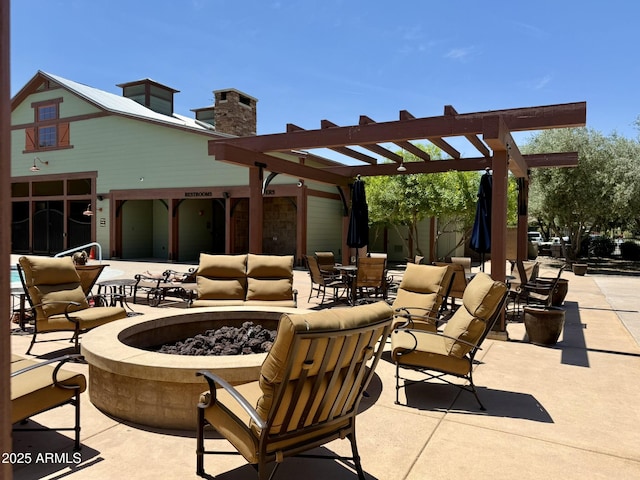 view of patio featuring a pergola and a fire pit