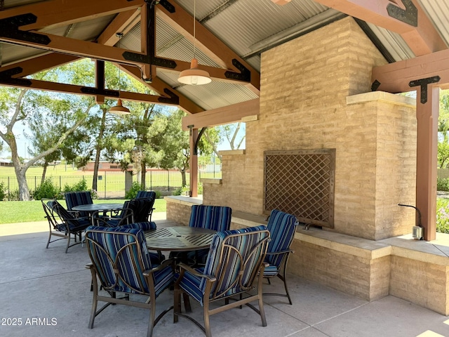 view of patio featuring a gazebo, fence, and outdoor dining area