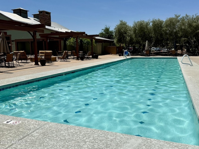 pool with a pergola and a patio