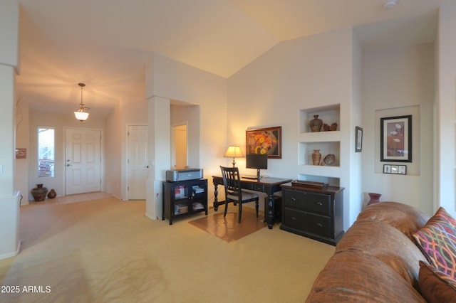 home office with built in shelves, light colored carpet, and lofted ceiling