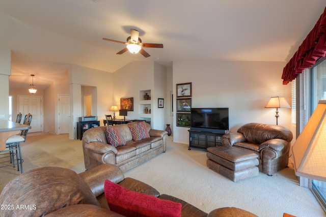 carpeted living room featuring ceiling fan and vaulted ceiling