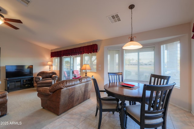 tiled dining area featuring ceiling fan and lofted ceiling