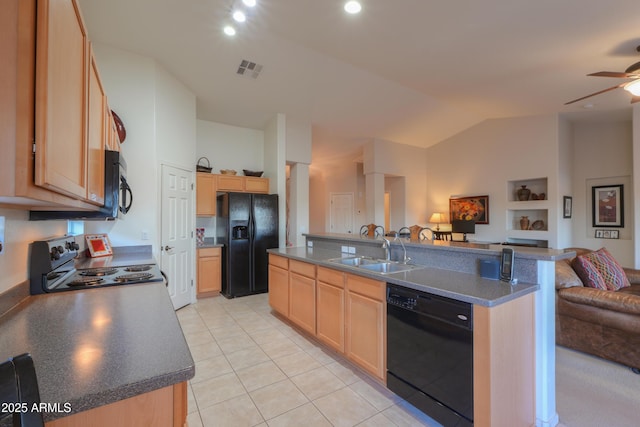 kitchen featuring sink, an island with sink, and black appliances