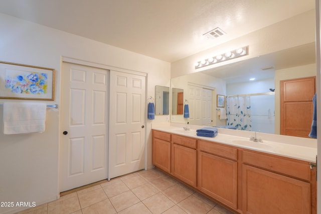 bathroom featuring tile patterned floors, curtained shower, and vanity