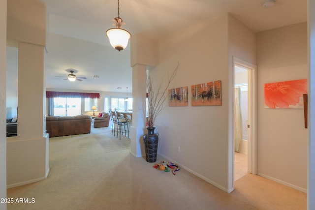 hall featuring light colored carpet